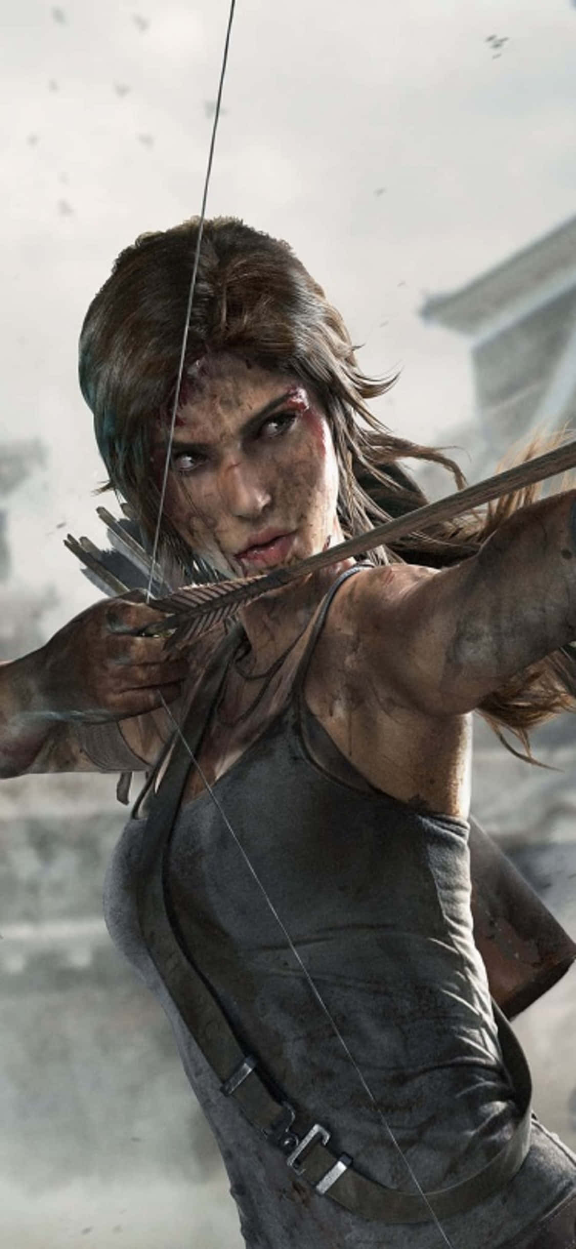 টুম রেইডার একটি শহরের দিকে তার ধনুক তাক করছে ওয়ালপেপার
